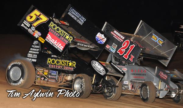 Battling here with Jimmy Hurley (21x), current Lucas Oil Sprint Car points leader Shane Stewart established himself as an early frontrunner for 24th Annual COMP Cams Short Track Nationals presented by Hoosier Tires honors by winning both his heat race and qualifying race before rain cut Thursday night's action short at Little Rock's I-30 Speedway. (Tim Aylwin photo)